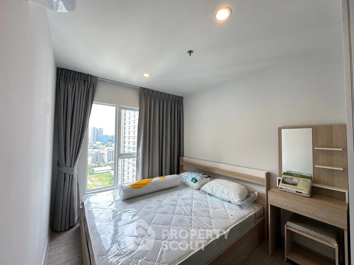 Cozy bedroom with city view, modern furnishings, and ample natural light.