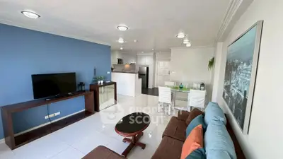 Spacious living room with modern decor and open kitchen layout