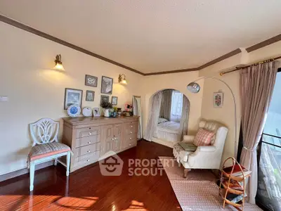 Charming living room with elegant decor and cozy seating area, featuring warm wooden flooring and natural light.
