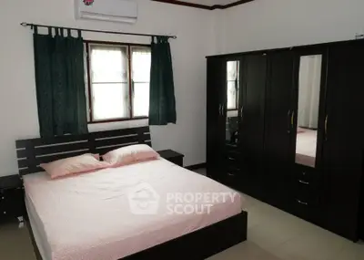 Cozy bedroom with modern furniture and natural light, perfect for relaxation and comfort.