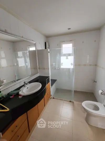 Spacious bathroom with modern fixtures and glass shower enclosure