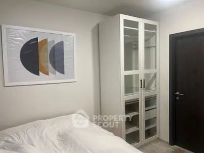 Cozy bedroom with modern art and sleek wardrobe design