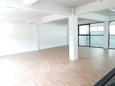 Spacious open-plan interior with modern flooring and large windows
