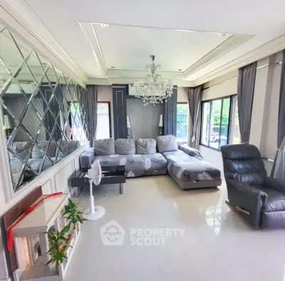 Luxurious living room with elegant chandelier and large windows