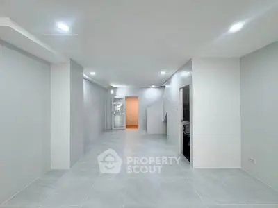 Spacious modern interior with sleek design and ample lighting, perfect for versatile living arrangements.