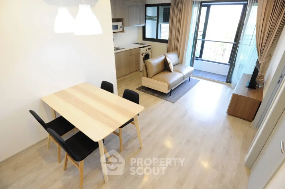 Modern open-plan living room with kitchen and balcony in stylish apartment