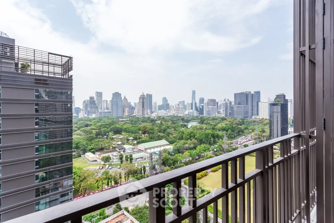 Stunning cityscape view from a high-rise balcony overlooking lush greenery and urban skyline.