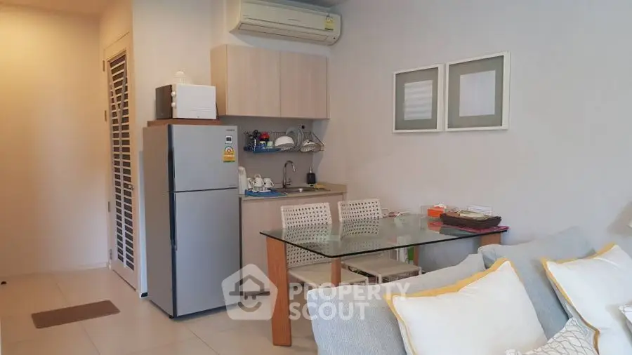 Cozy modern living room with compact kitchen and stylish decor