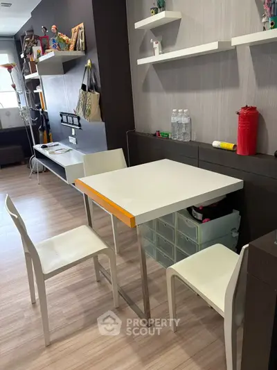 Modern study area with sleek table and chairs, stylish shelves, and contemporary decor.