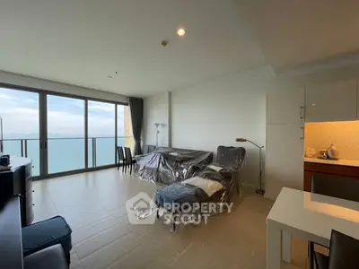 Spacious living room with ocean view and modern furnishings in luxury apartment