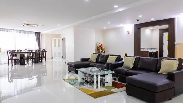 Spacious modern living room with elegant dining area and stylish furniture.