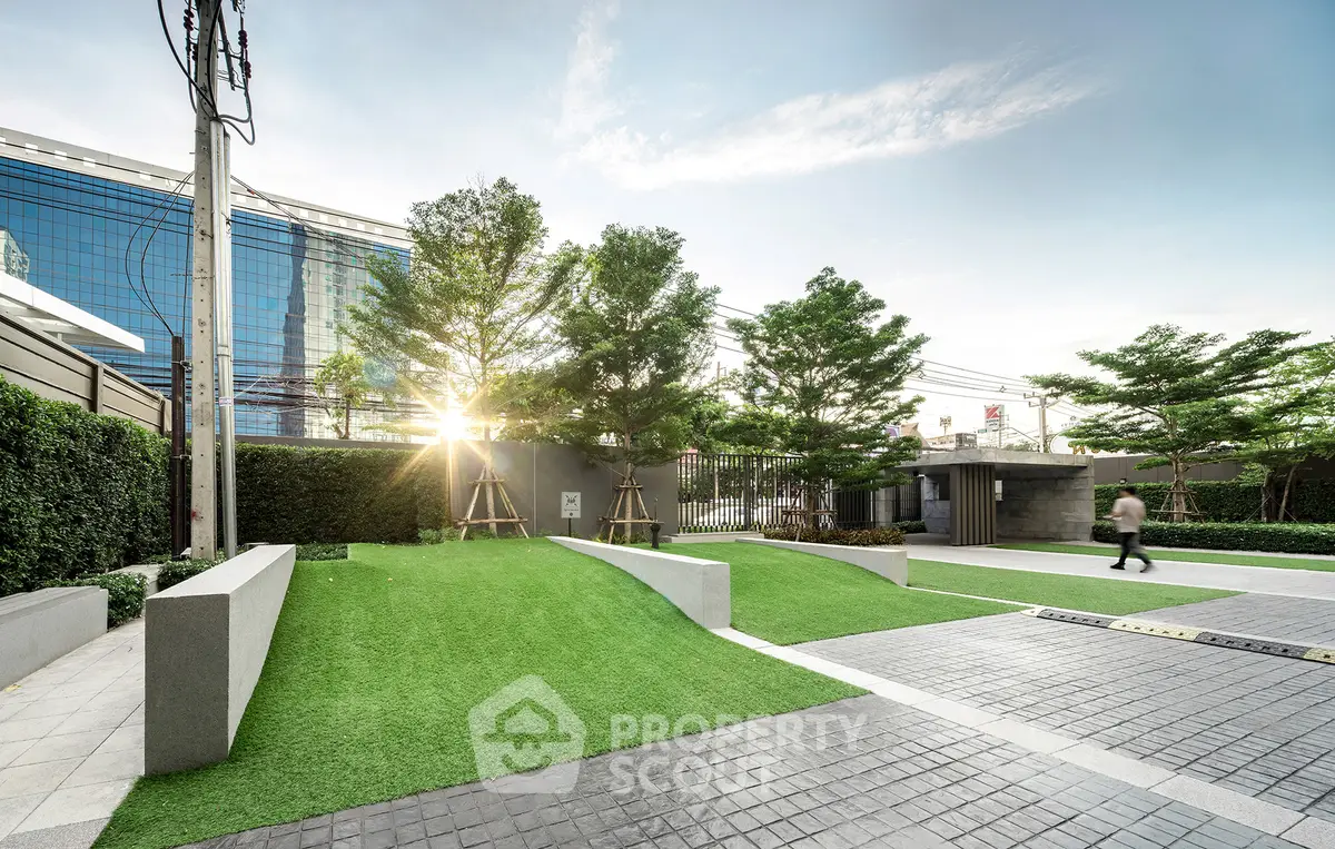 Modern landscaped garden with lush greenery and sleek pathways in urban setting.