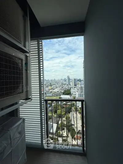 Stunning cityscape view from a high-rise balcony with modern design and ample natural light.