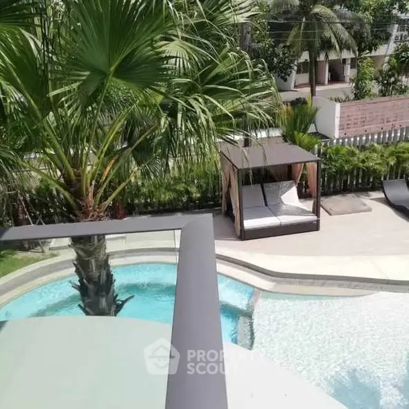 Luxurious poolside view with lush greenery and modern cabana