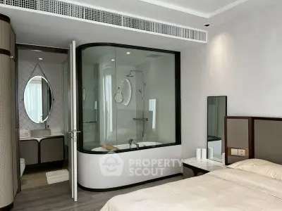 Modern bedroom with unique glass-enclosed bathtub and elegant decor