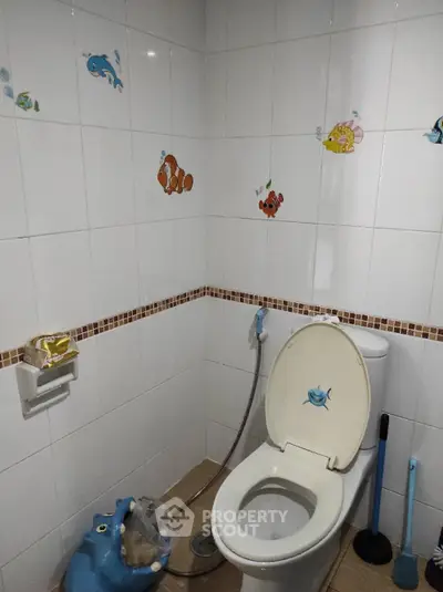 Charming bathroom with playful fish-themed decor and modern fixtures.