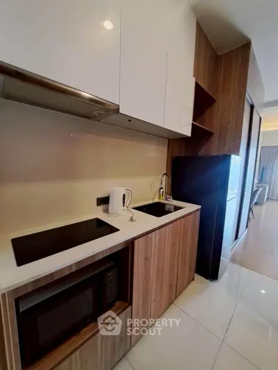 Modern kitchen with sleek appliances and wooden cabinetry