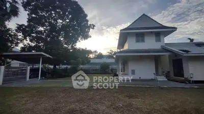 Charming suburban house with spacious garden and carport, perfect for family living.