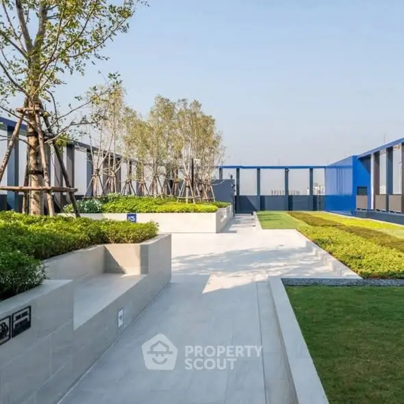 Modern rooftop garden with sleek design and lush greenery.