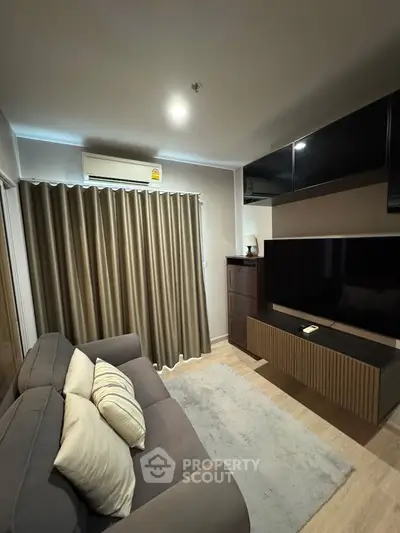 Cozy living room with modern decor and large TV unit