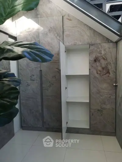 Modern storage space with sleek marble finish and hidden shelving.