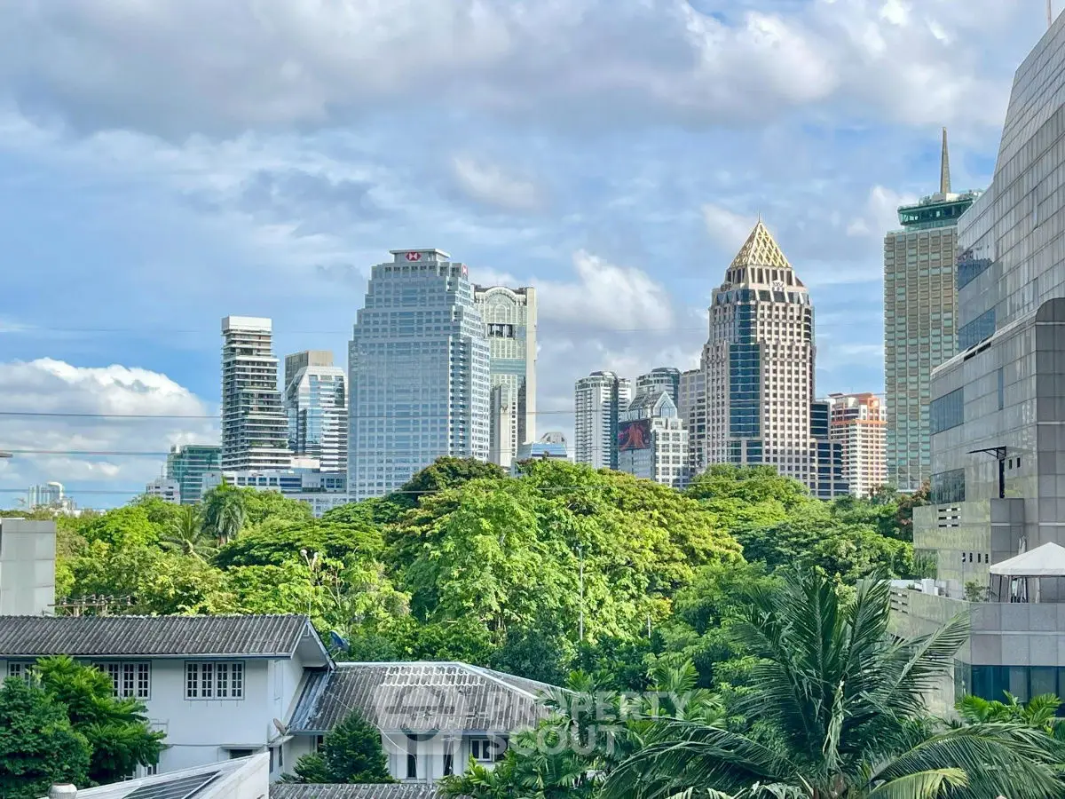 Stunning city skyline view with lush greenery and modern skyscrapers.