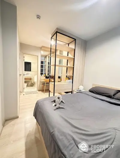 Modern bedroom with ensuite bathroom and stylish shelving unit