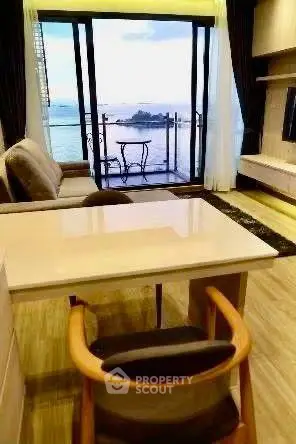 Luxurious living room with stunning ocean view and elegant balcony.