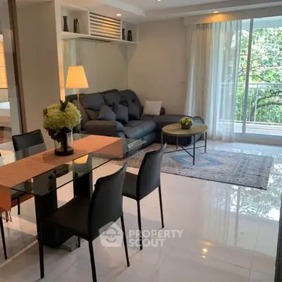Modern living room with elegant dining area and cozy seating, featuring a large window with lush garden view.