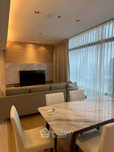 Luxurious modern living room with city view, elegant marble dining table, and cozy seating area.