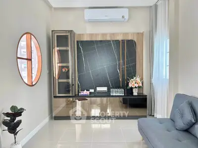 Modern living room with sleek design, featuring a stylish cabinet and elegant decor, perfect for contemporary living.