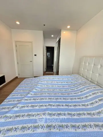 Spacious bedroom with modern decor and ample natural light