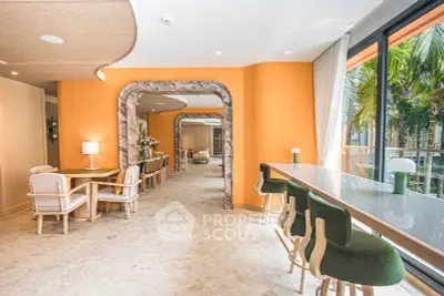 Luxurious modern interior with elegant dining area and large windows offering lush garden views.