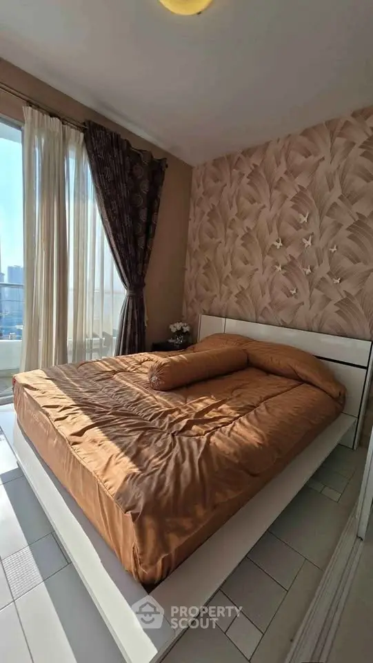 Cozy bedroom with stylish wallpaper and large window offering city views