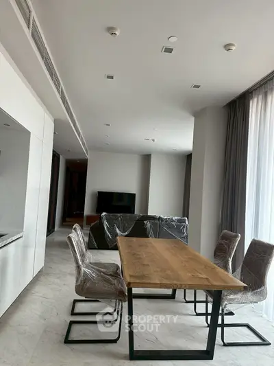 Modern dining area with sleek table and chairs in a stylish apartment