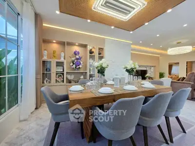 Luxurious dining area with elegant decor and modern lighting in a spacious open-plan living room.