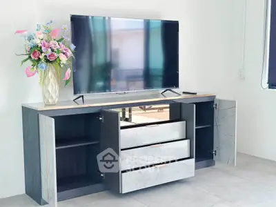 Modern living room with sleek TV stand and floral decor