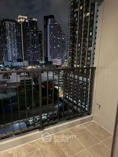Stunning city view from a modern high-rise balcony at night, perfect for urban living.