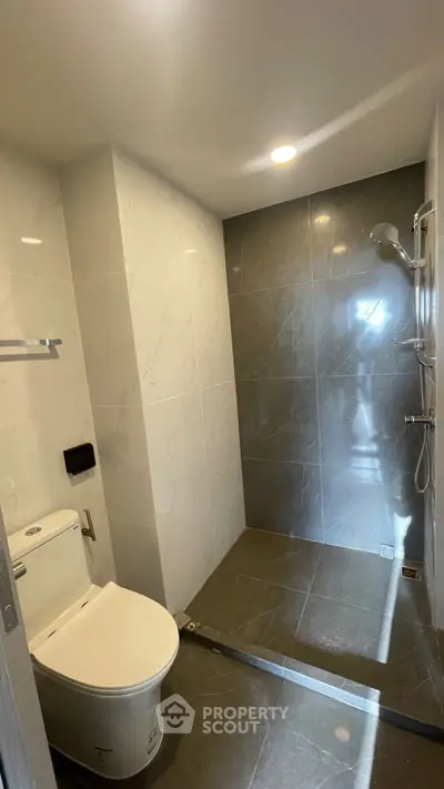 Modern bathroom with sleek tiles and walk-in shower design
