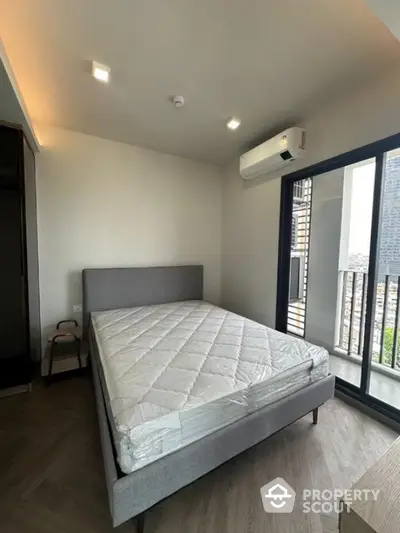 Modern bedroom with balcony view in high-rise apartment