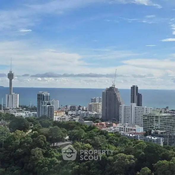 Stunning cityscape with ocean view and modern high-rise buildings.