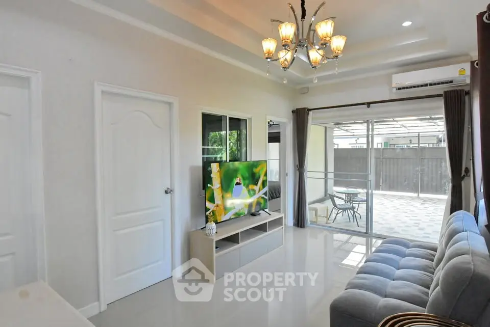 Modern living room with elegant chandelier and spacious seating area