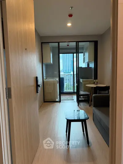 Modern apartment entrance leading to a cozy living area with a view of the city skyline.