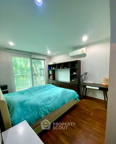 Cozy bedroom with balcony view and modern furnishings