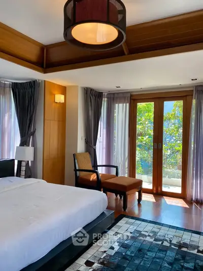 Luxurious bedroom with large windows and elegant decor, offering a serene and inviting atmosphere.