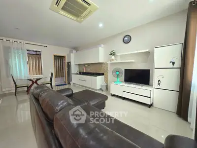 Spacious modern living room with sleek furniture and open kitchen layout