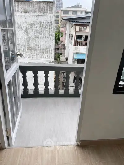 Charming balcony view from a cozy apartment, perfect for enjoying cityscape views and fresh air.
