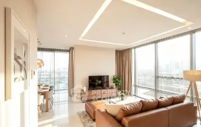 Luxurious modern living room with panoramic city views and elegant furnishings.