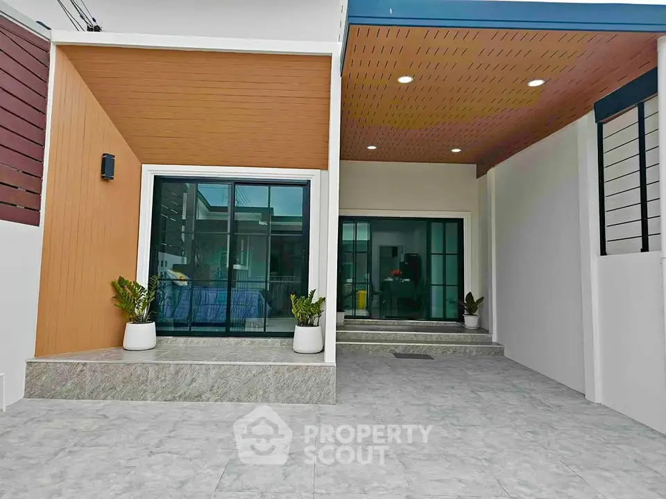 Modern house entrance with sleek design and potted plants