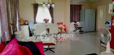 Spacious living room with modern decor and dining area, featuring elegant lighting and ample natural light.